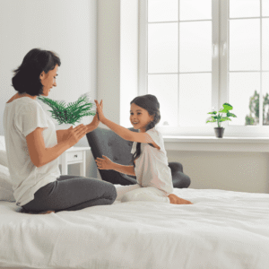 Mother and daughter high-fiving on a Direct Outlet mattress in a North Carolina home